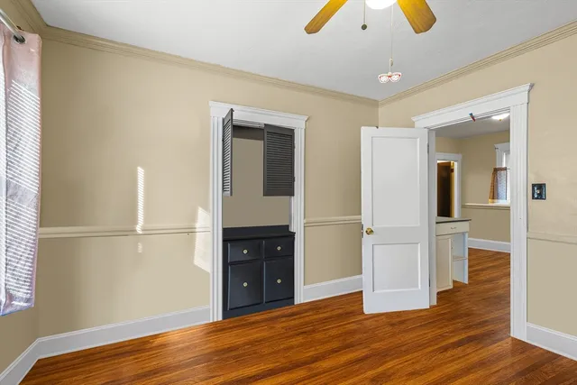 a view of empty room with wooden floor