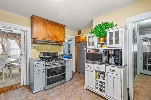 a kitchen with stainless steel appliances a stove a sink and a refrigerator