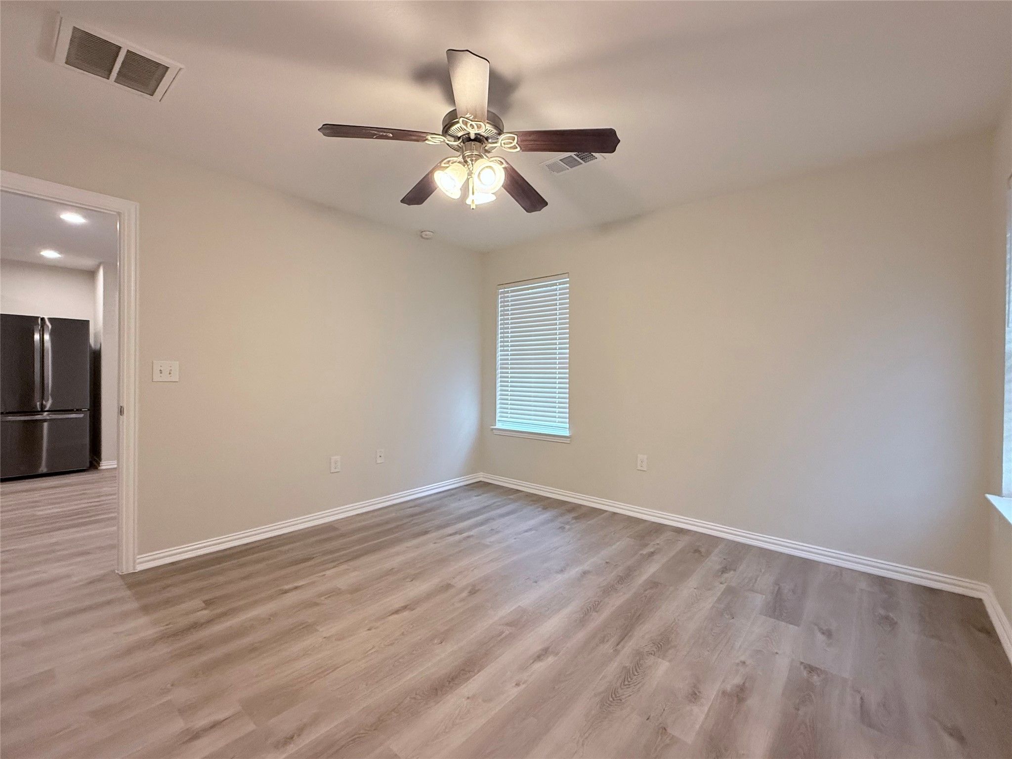 3907 Faulkner Street Houston, TX 77021 - Photo 11 of 17 a view of an empty room with wooden floor and a ceiling fan