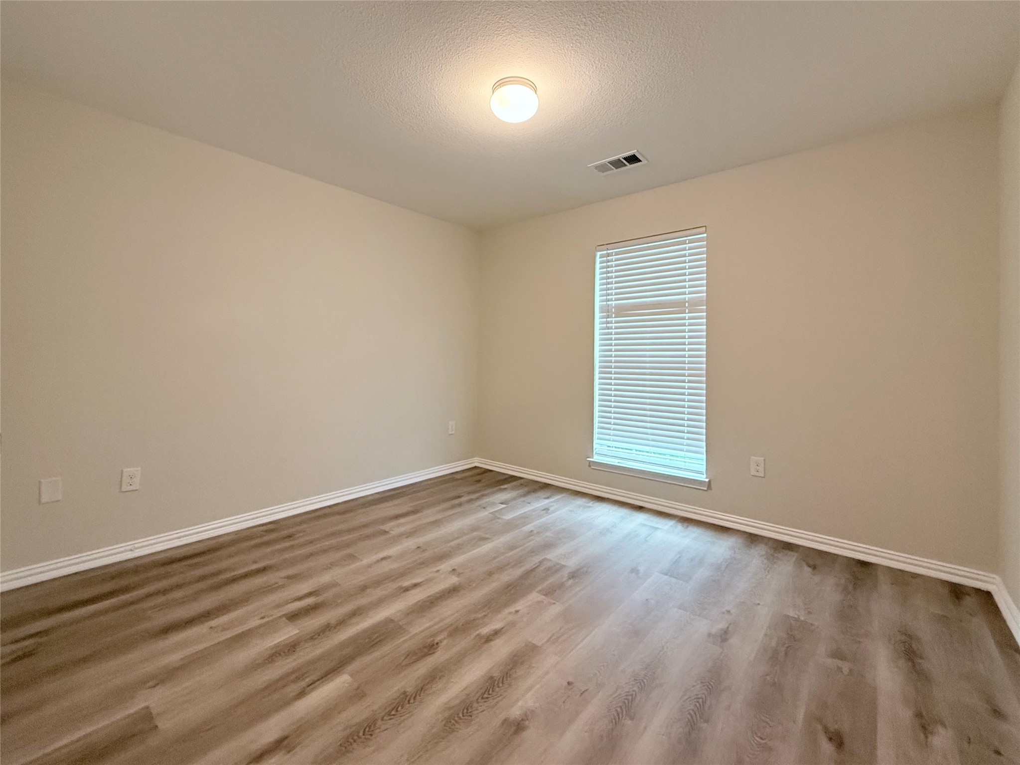 3907 Faulkner Street Houston, TX 77021 - Photo 14 of 17 a view of an empty room with wooden floor and a window