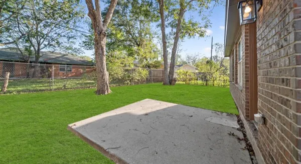 a view of a backyard with large trees