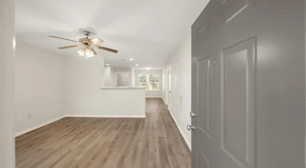 wooden floor in an empty room with a window