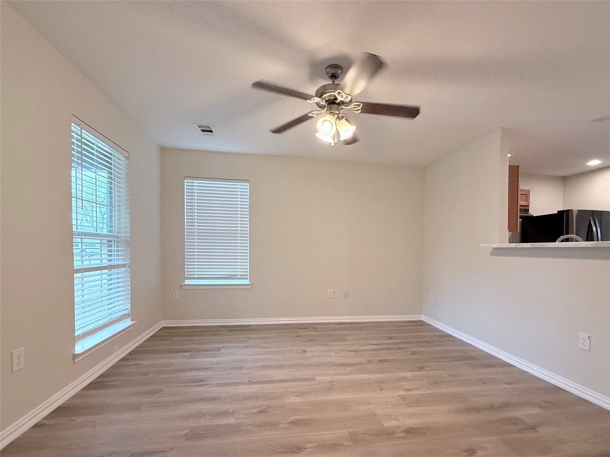 3907 Faulkner Street Houston, TX 77021 - Photo 5 of 17 a view of an empty room with a window and wooden floor