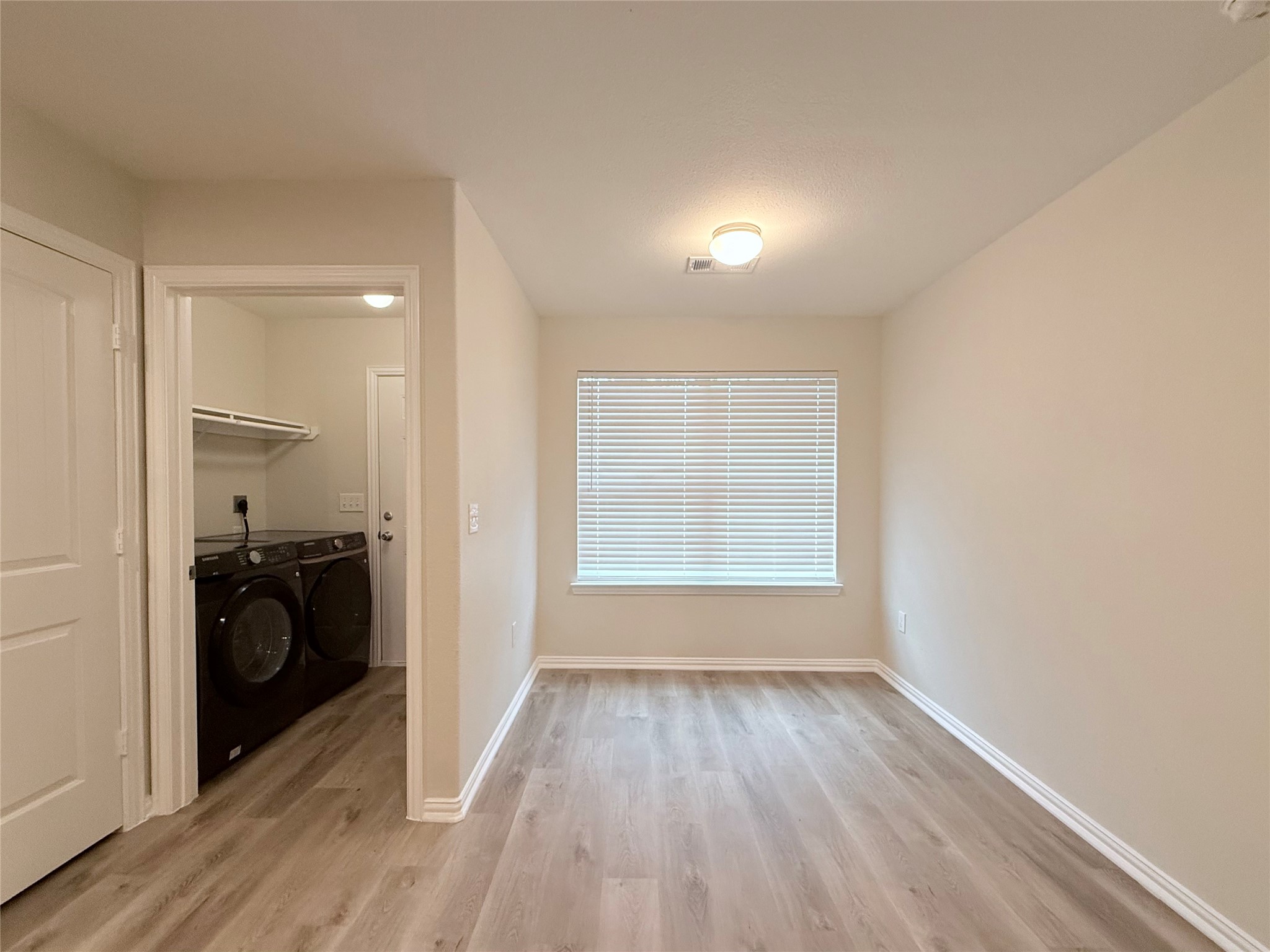 3907 Faulkner Street Houston, TX 77021 - Photo 9 of 17 wooden floor in an empty room with a kitchen