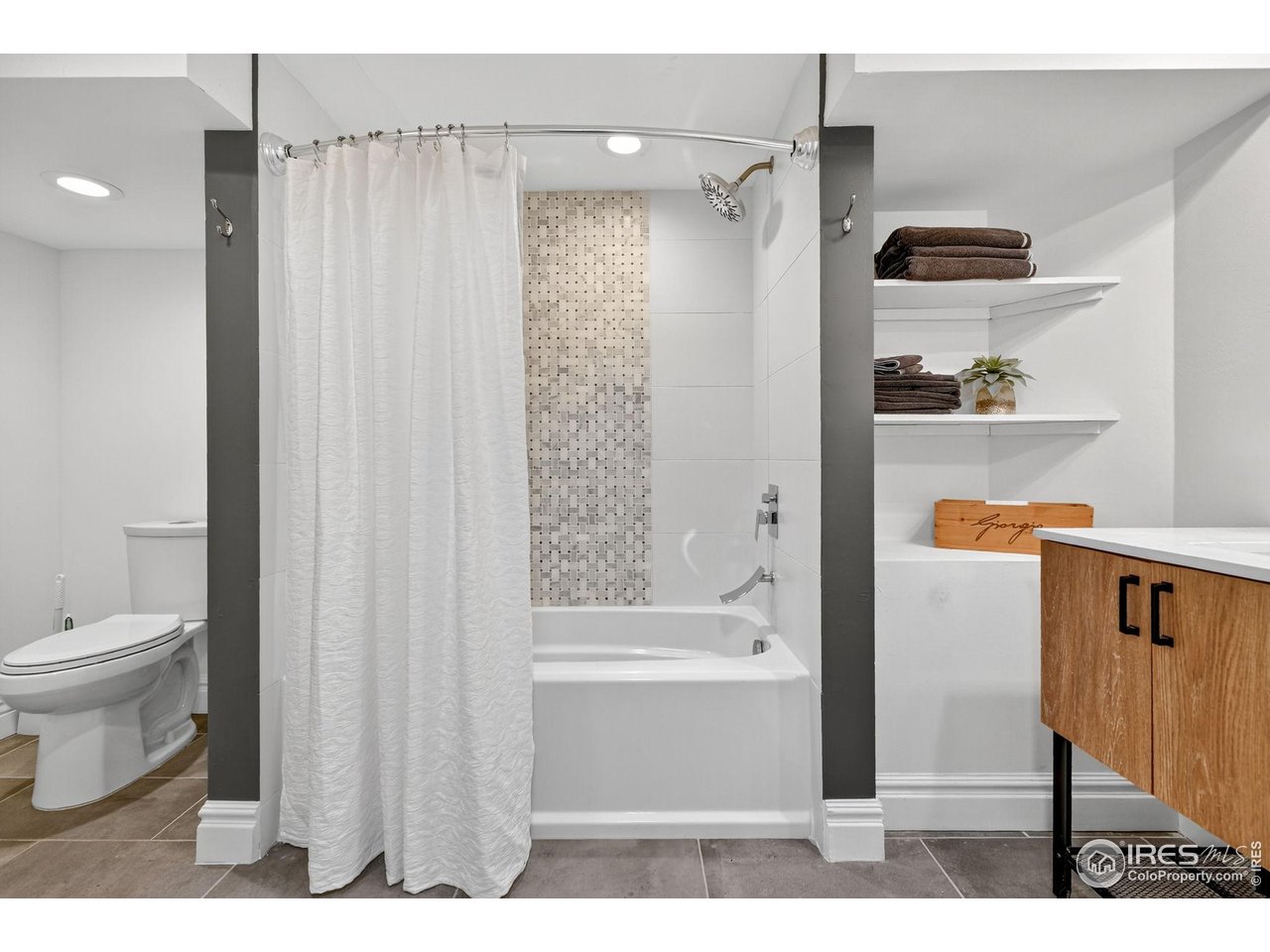 2065 Holly Street Denver, CO 80207 - Photo 27 of 46 Large Remodeled Basement Bath with custom fixtures and tile