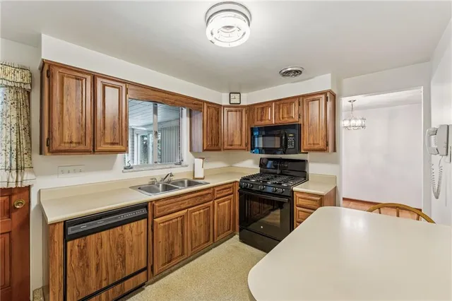 a kitchen with a sink a stove and cabinets