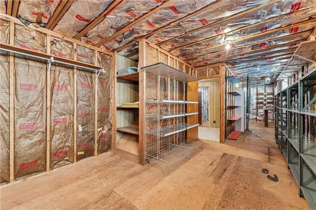 a view of an empty room with wooden walls