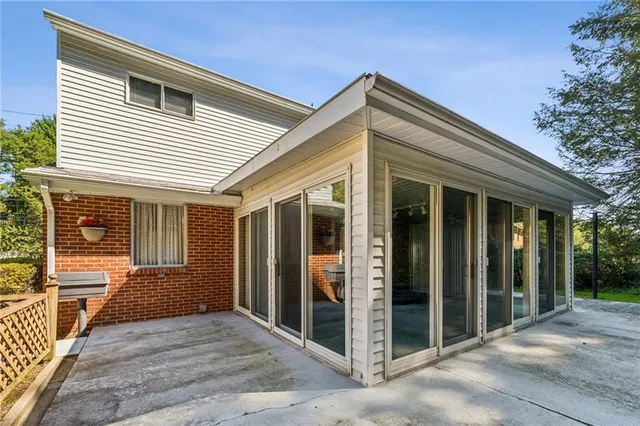 a view of a house with a yard and potted plants