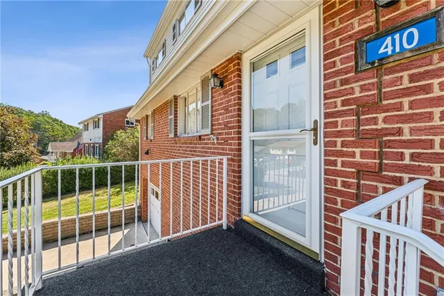 a view of a balcony with a floor to ceiling window and wooden fence