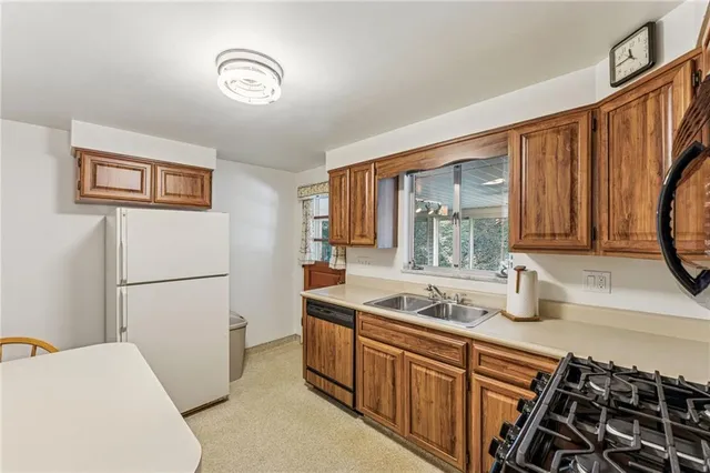 a kitchen with stainless steel appliances a refrigerator and a sink