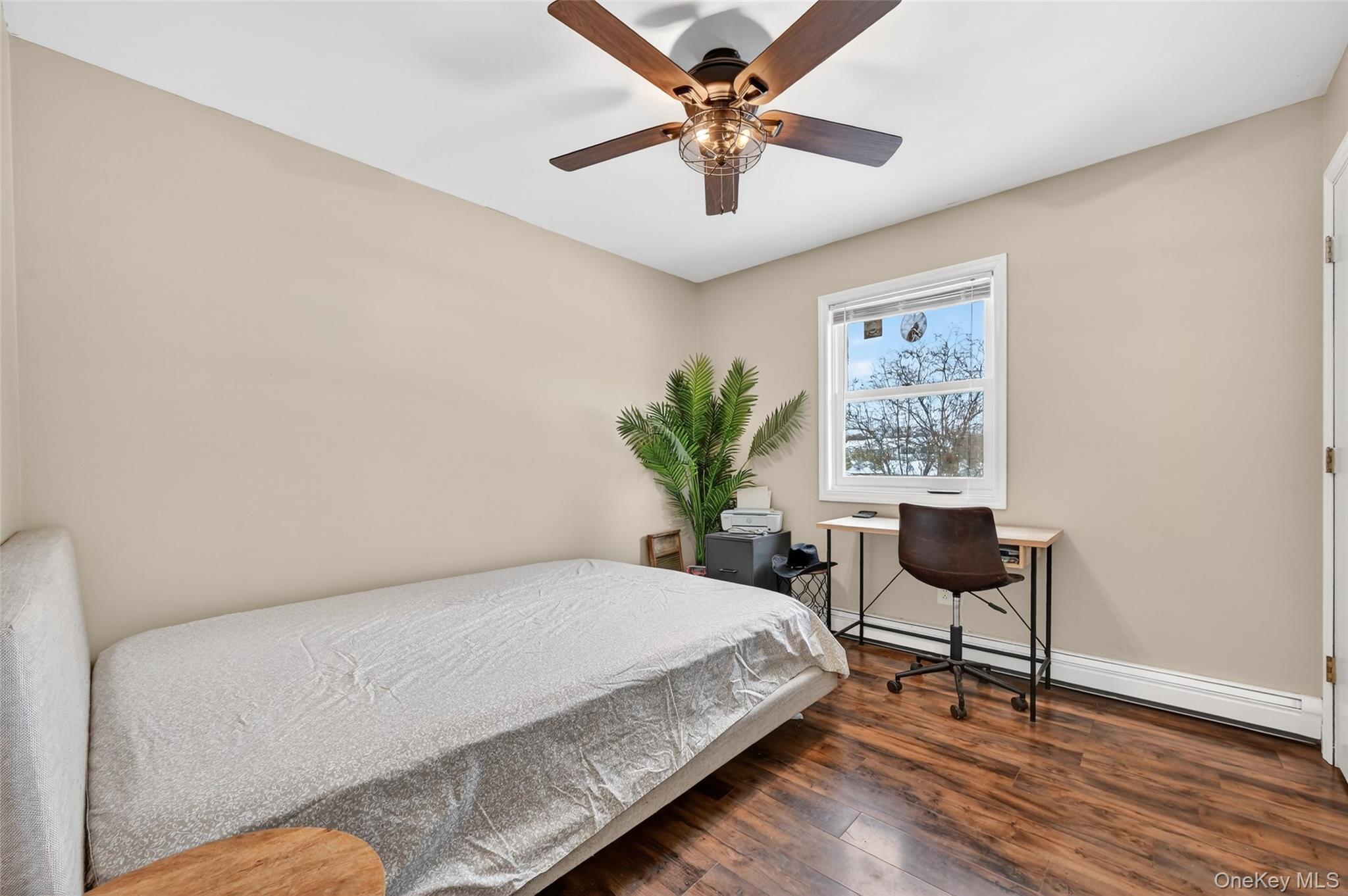 917 Scotchtown Collabar Road Middletown, NY 10941 - Photo 17 of 33 a bedroom with a bed and a chair