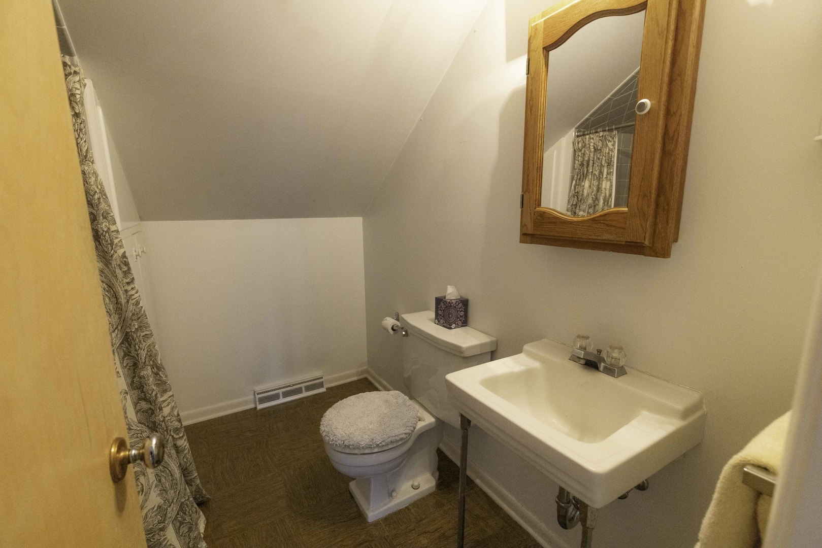 853 Cramer Court Willowbrook, IL 60527 - Photo 21 of 27 a white toilet sitting next to a bathroom sink