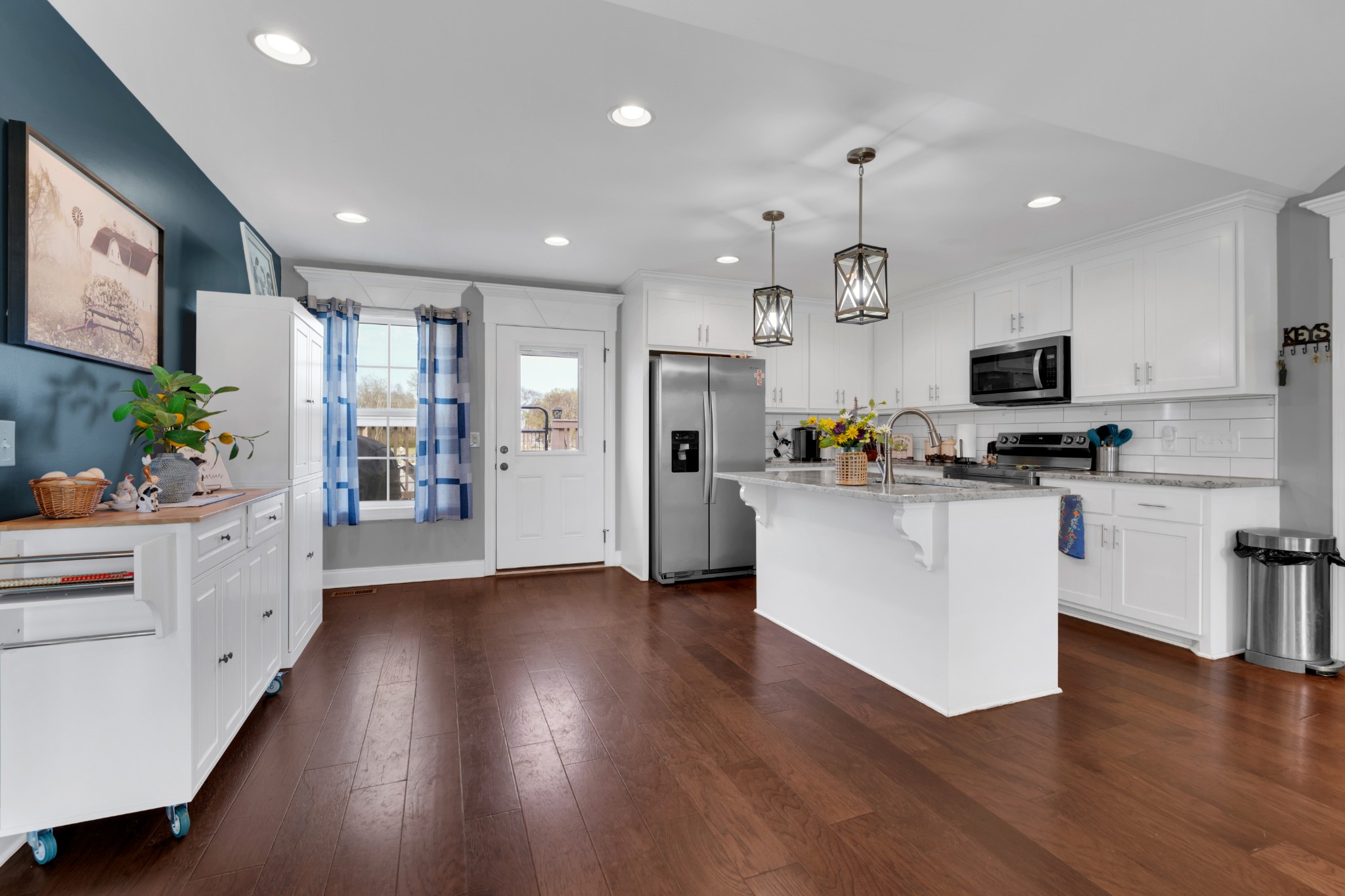 2058 Halls Mill Road Unionville, TN 37180 - Photo 25 of 67 a kitchen with stainless steel appliances granite countertop a refrigerator a stove top oven a sink dishwasher and white cabinets with wooden floor