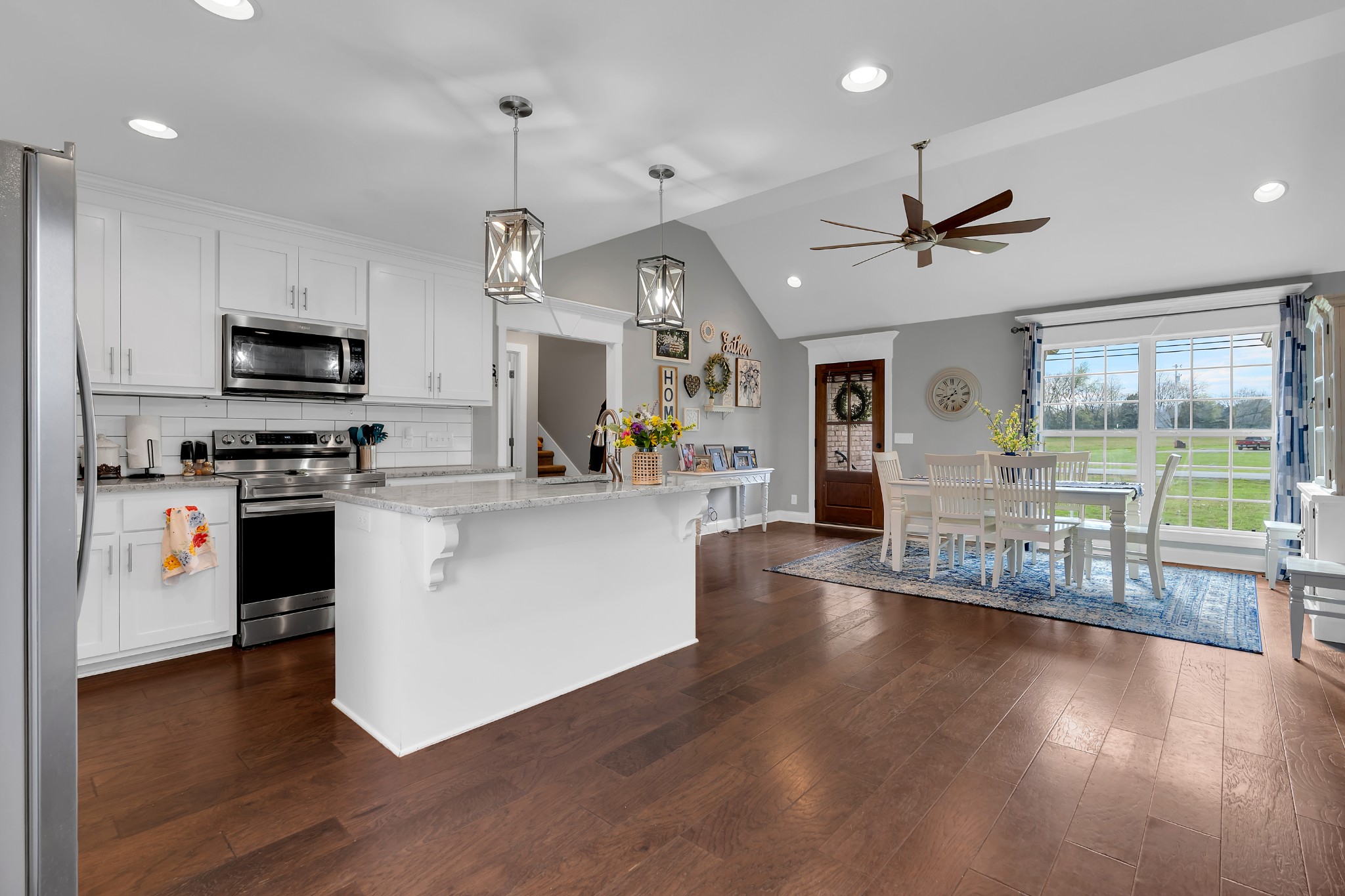 2058 Halls Mill Road Unionville, TN 37180 - Photo 32 of 67 a kitchen with stainless steel appliances granite countertop a refrigerator a stove top oven a sink dishwasher a dining table and chairs with wooden floor
