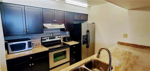 a kitchen with a stove and a microwave