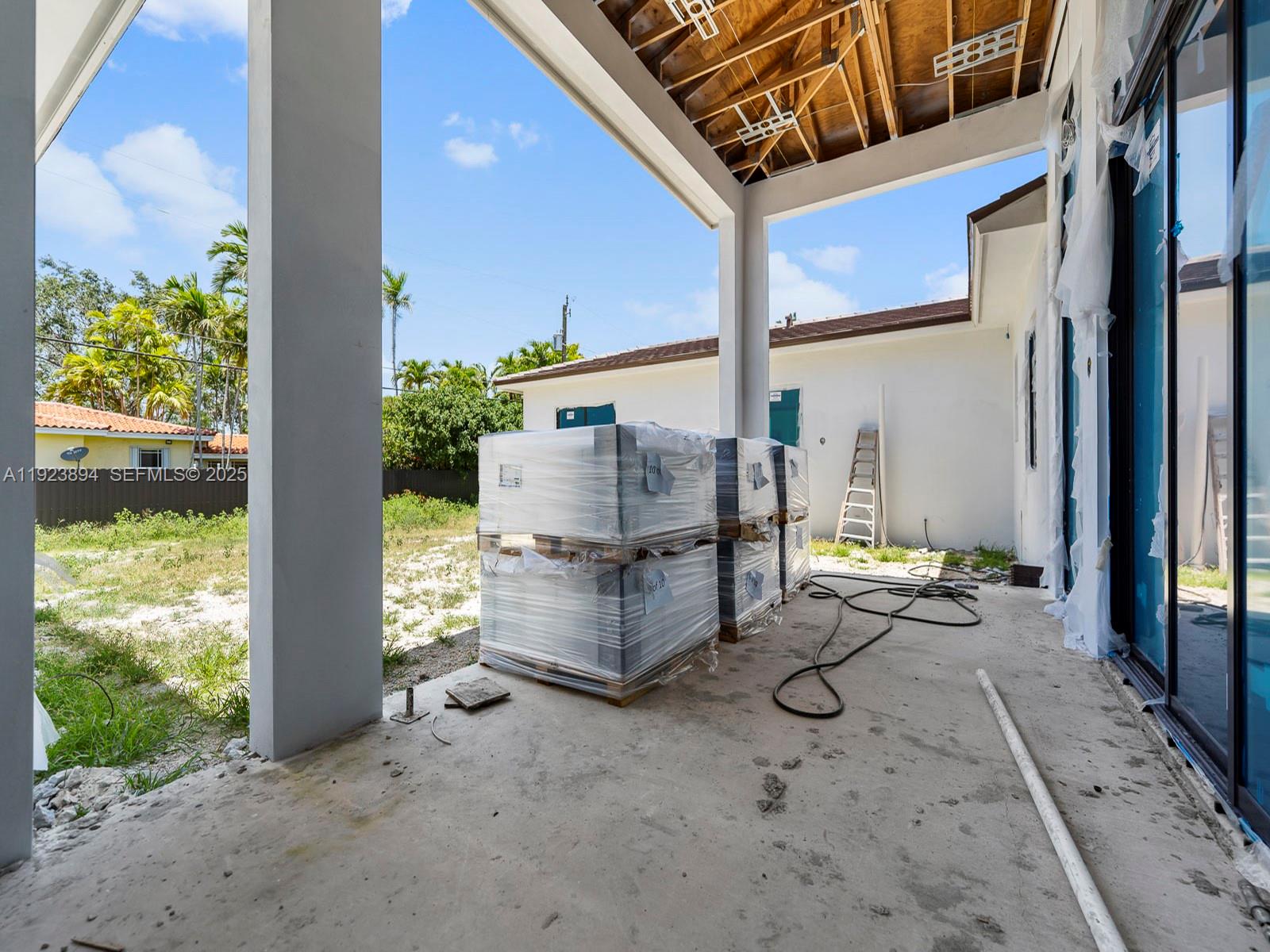 8275 Southwest 93rd Street Miami, FL 33156 - Photo 14 of 47 a building outdoor space with patio furniture and potted plants