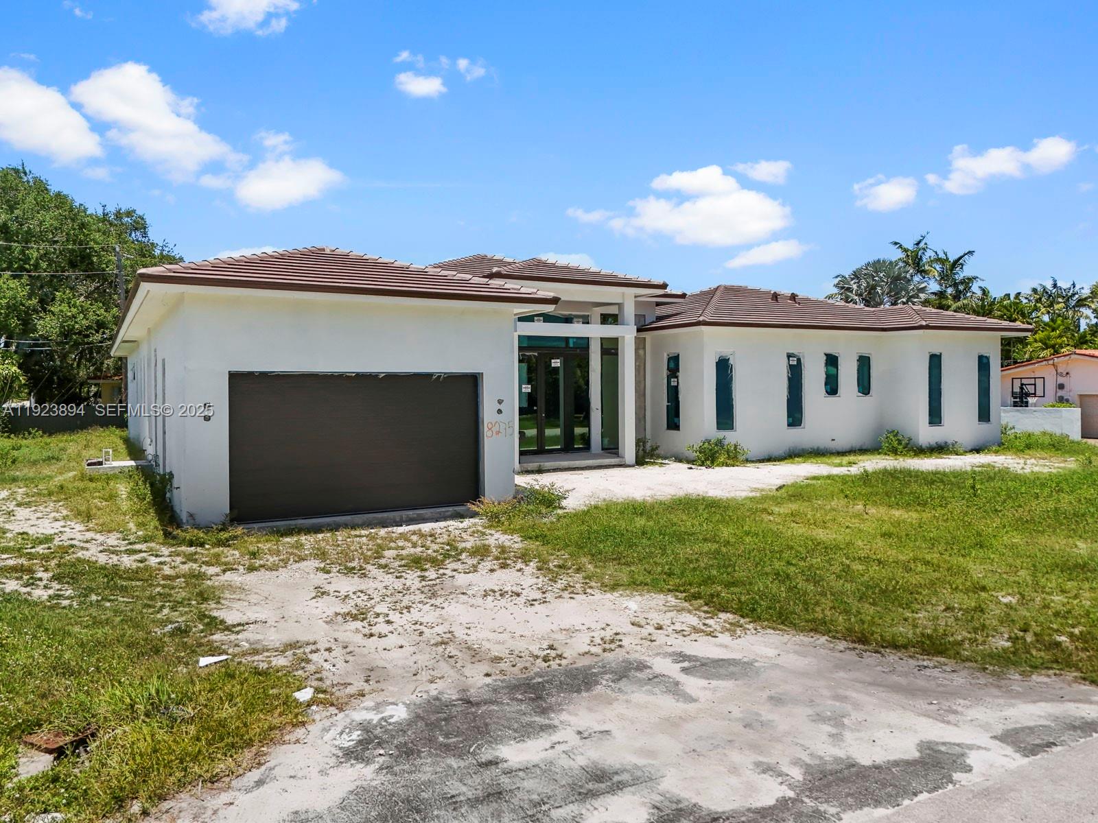 8275 Southwest 93rd Street Miami, FL 33156 - Photo 5 of 47 a front view of a house with a garden