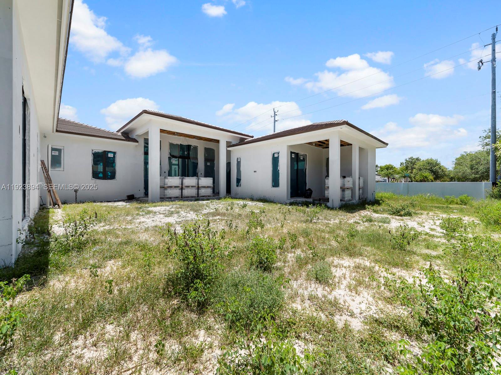 8275 Southwest 93rd Street Miami, FL 33156 - Photo 10 of 47 a front view of house with yard and trees around