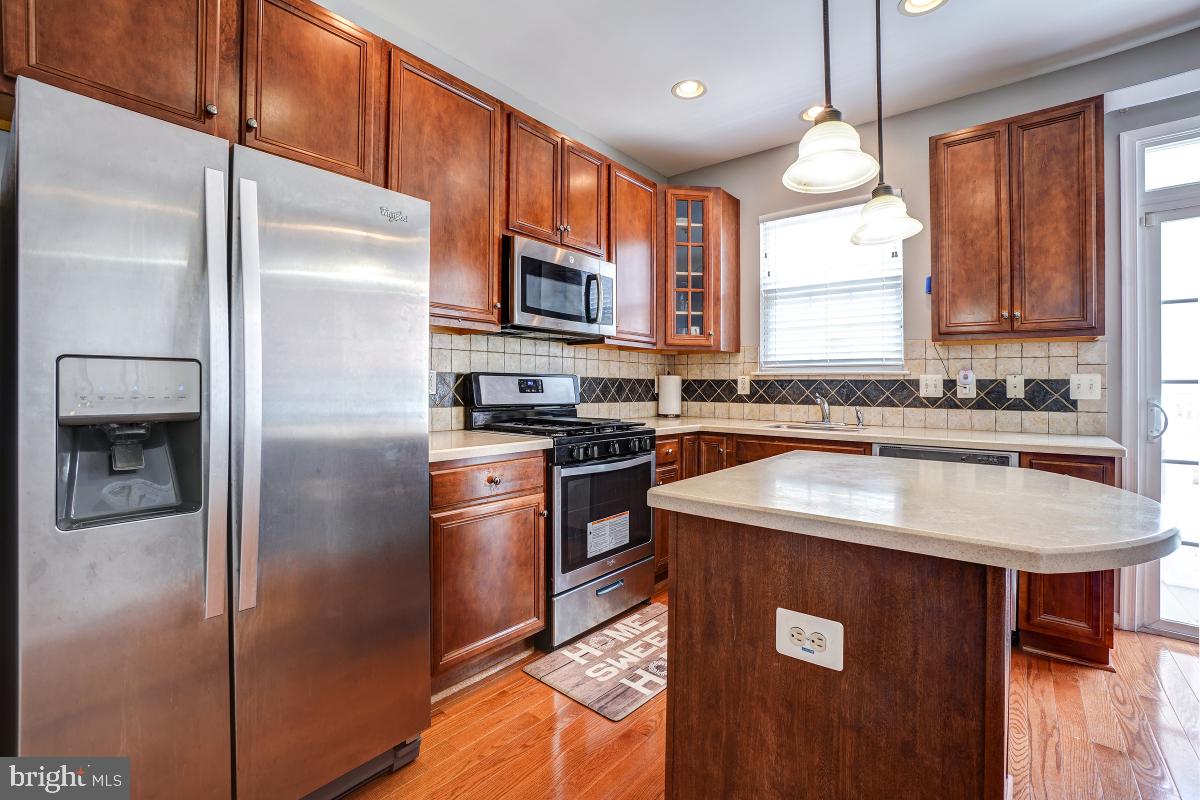 4281 South Capitol Street Southwest Washington, DC 20032 - Photo 35 of 71 a kitchen with stainless steel appliances granite countertop a refrigerator a sink a stove a microwave and island