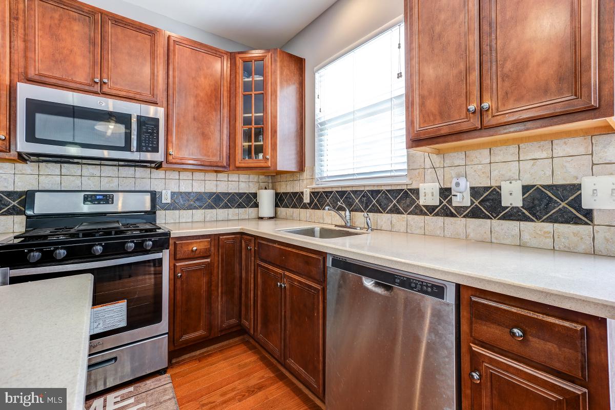 4281 South Capitol Street Southwest Washington, DC 20032 - Photo 37 of 71 a kitchen with stainless steel appliances granite countertop a sink stove and microwave