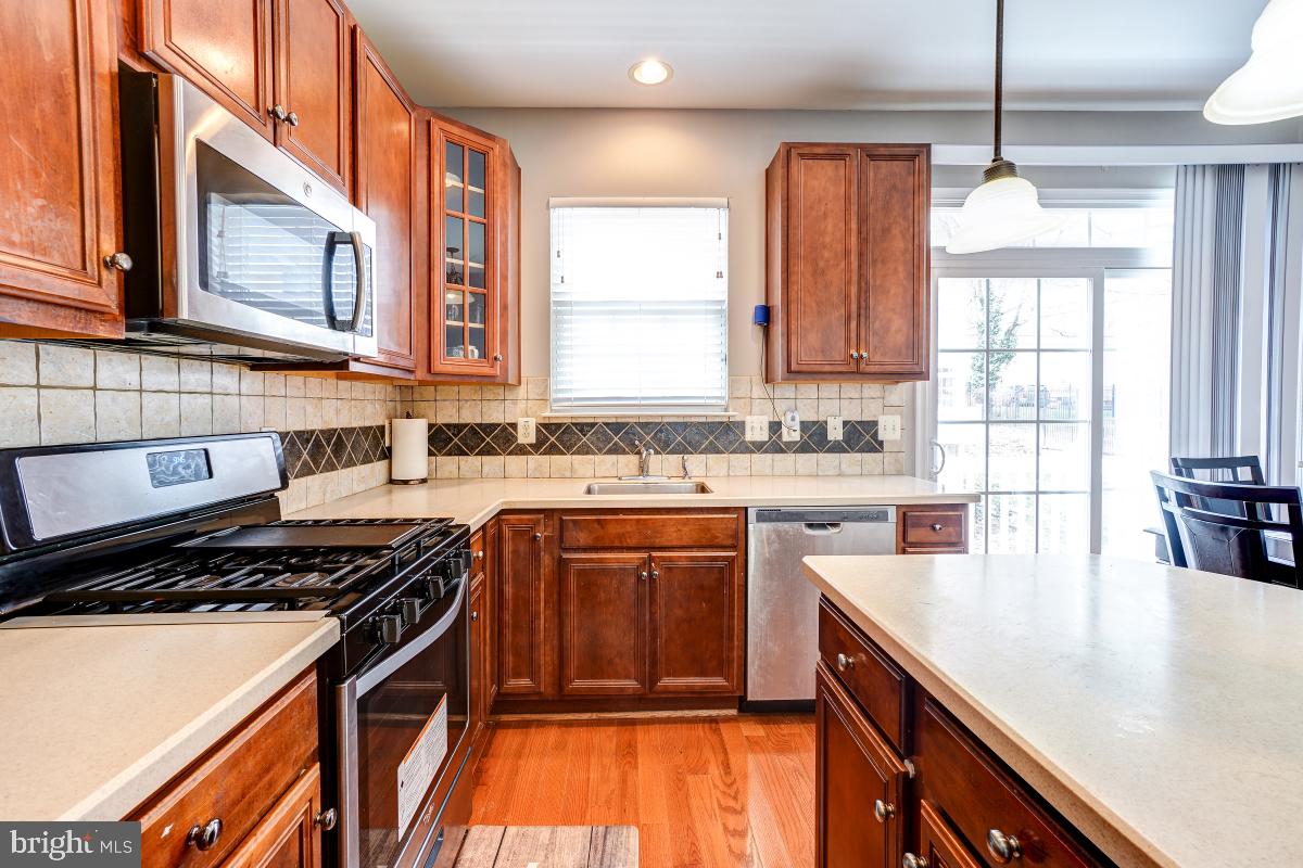 4281 South Capitol Street Southwest Washington, DC 20032 - Photo 38 of 71 a kitchen with stainless steel appliances granite countertop a stove a sink and a microwave