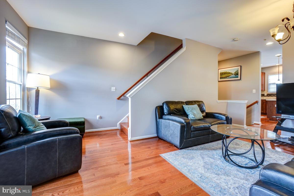 4281 South Capitol Street Southwest Washington, DC 20032 - Photo 51 of 71 a living room with furniture and a flat screen tv with wooden floor