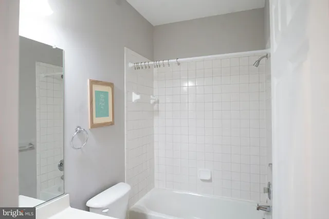 a kitchen with stainless steel appliances granite countertop a sink a stove a refrigerator and island with wooden floor