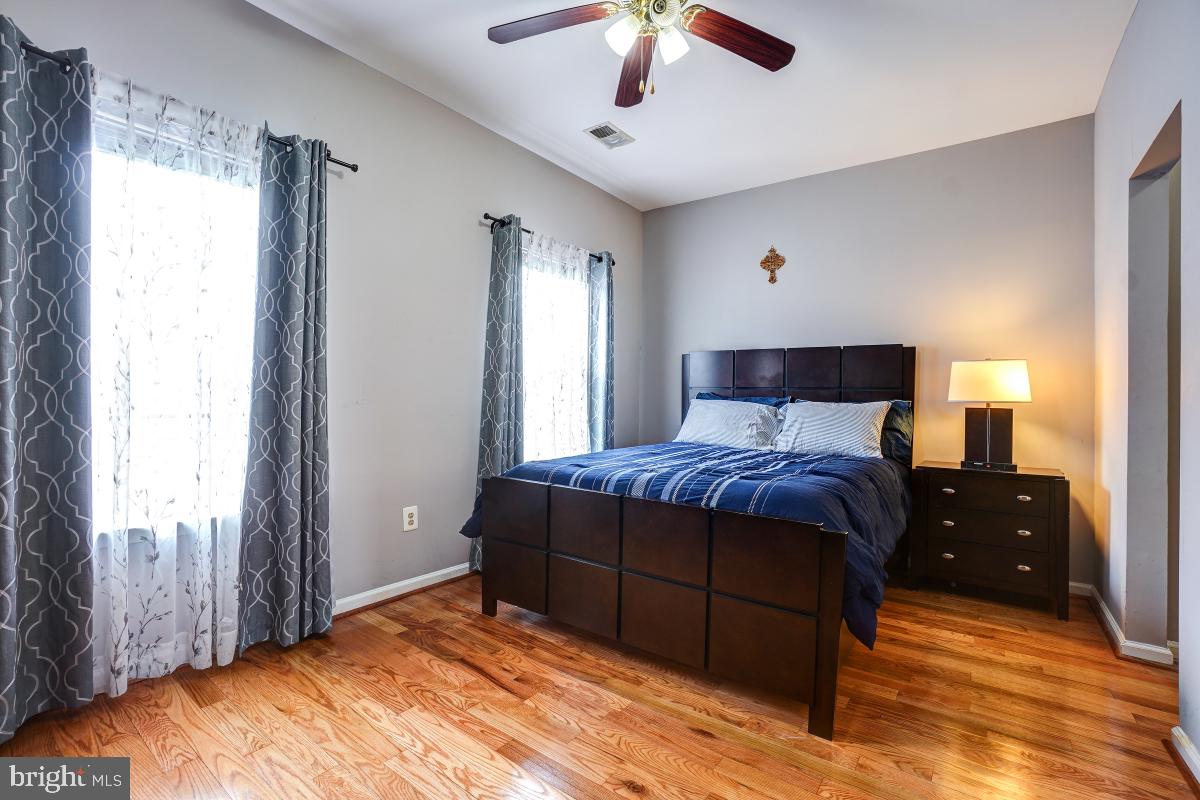 4281 South Capitol Street Southwest Washington, DC 20032 - Photo 61 of 71 a bedroom with a large bed and a chandelier