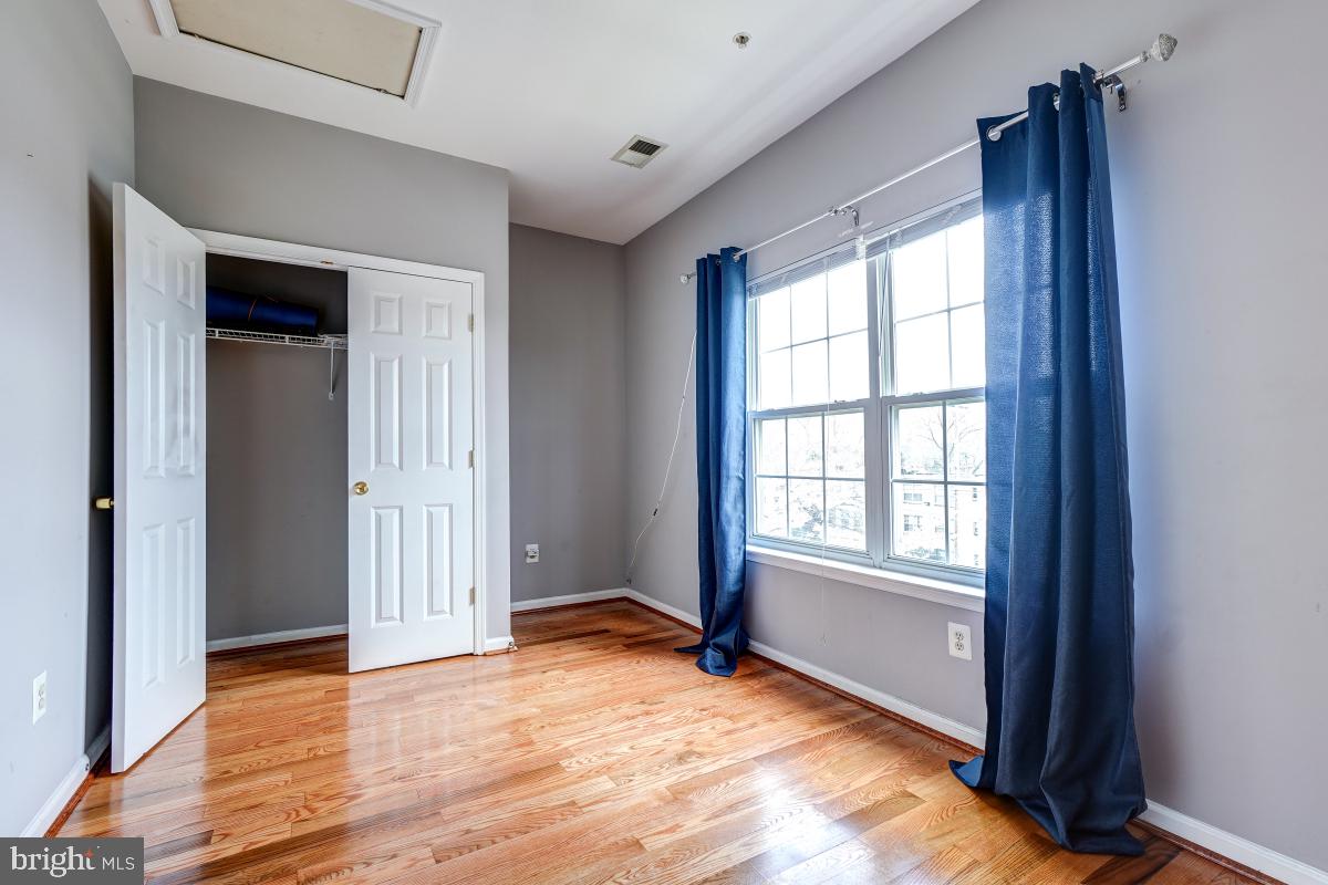 4281 South Capitol Street Southwest Washington, DC 20032 - Photo 65 of 71 an empty room with wooden floor and windows