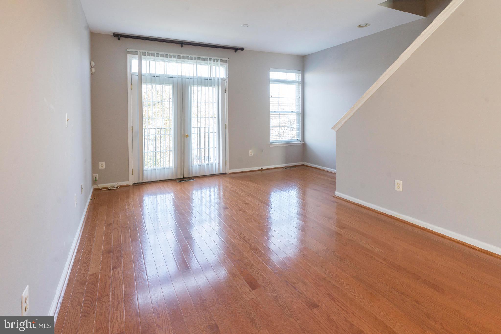 4281 South Capitol Street Southwest Washington, DC 20032 - Photo 7 of 71 a view of an empty room with wooden floor and a window