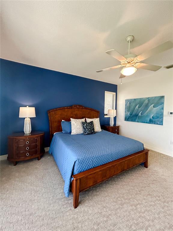 7303 Midnight Pass Road Sarasota, FL 34242 - Photo 12 of 22 a bedroom with a bed and a chandelier