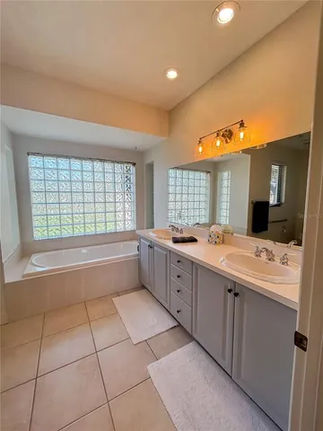 a bedroom with two beds and a chandelier