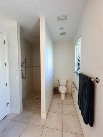 a bedroom with two beds and painting on the wall