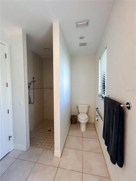 7303 Midnight Pass Road Sarasota, FL 34242 - Photo 16 of 22 a bathroom with a toilet sink and shower