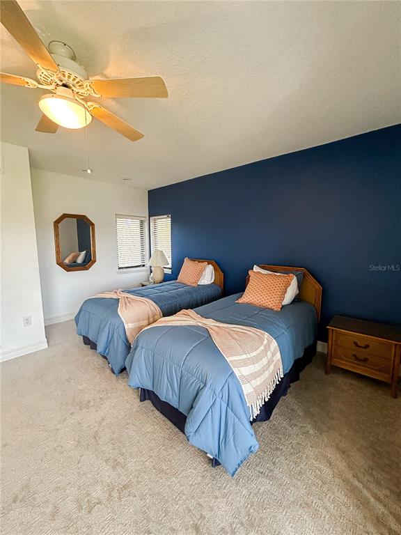 7303 Midnight Pass Road Sarasota, FL 34242 - Photo 18 of 22 a bedroom with two beds and painting on the wall