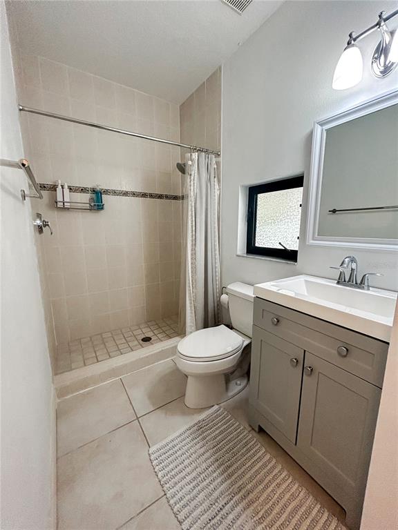 7303 Midnight Pass Road Sarasota, FL 34242 - Photo 20 of 22 a bathroom with a toilet sink and shower