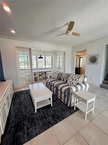 a living room with hard wood floor and furniture