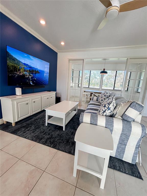 7303 Midnight Pass Road Sarasota, FL 34242 - Photo 4 of 22 a living room with furniture and a flat screen tv