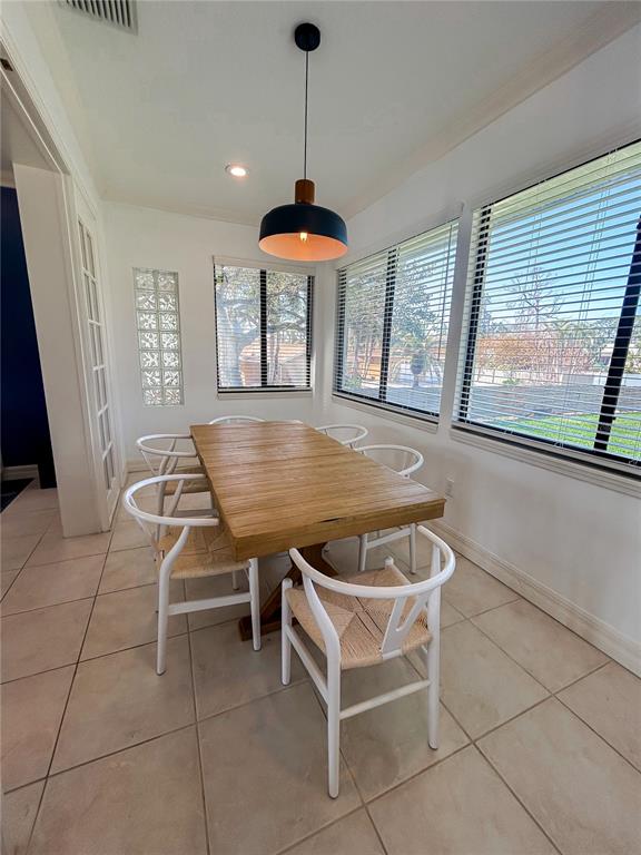 7303 Midnight Pass Road Sarasota, FL 34242 - Photo 8 of 22 a patio with a table and chairs