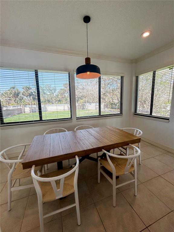 7303 Midnight Pass Road Sarasota, FL 34242 - Photo 9 of 22 a dining room with furniture and window