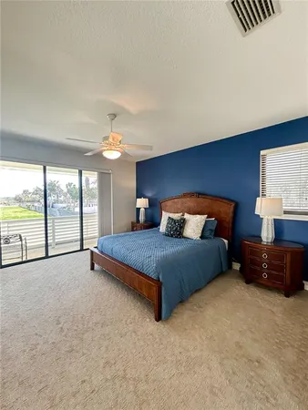 a spacious bedroom with a bed and a couch