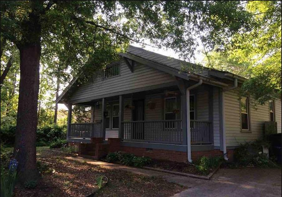 front view of a house with a garden