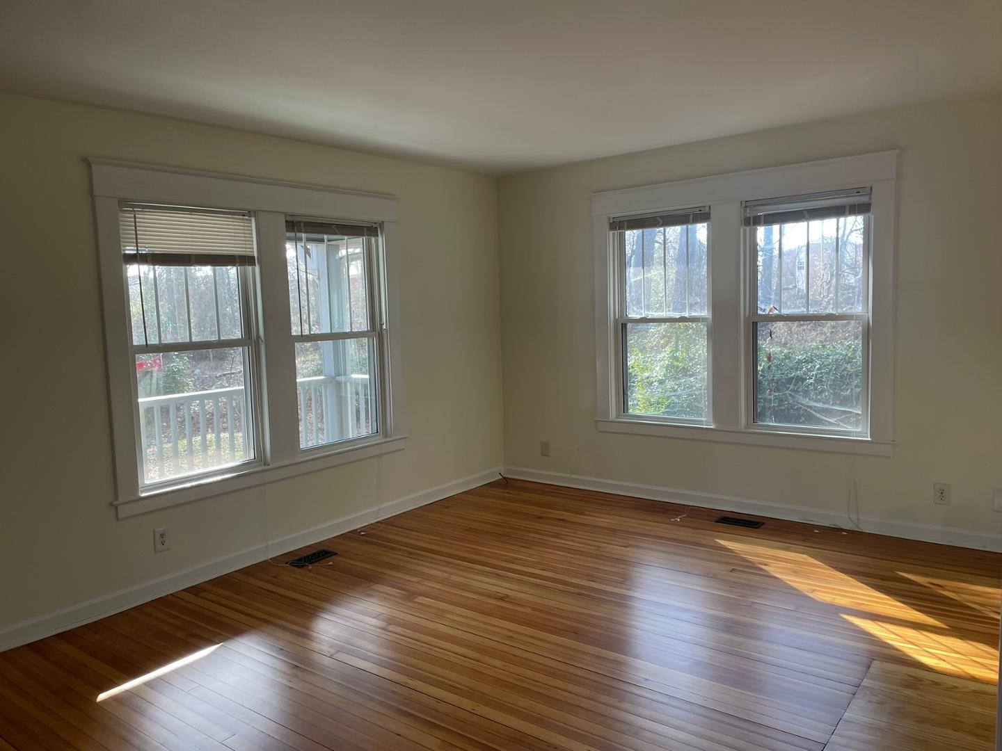 716 Crosby Road Durham, NC 27704 - Photo 5 of 17 an empty room with wooden floor and windows