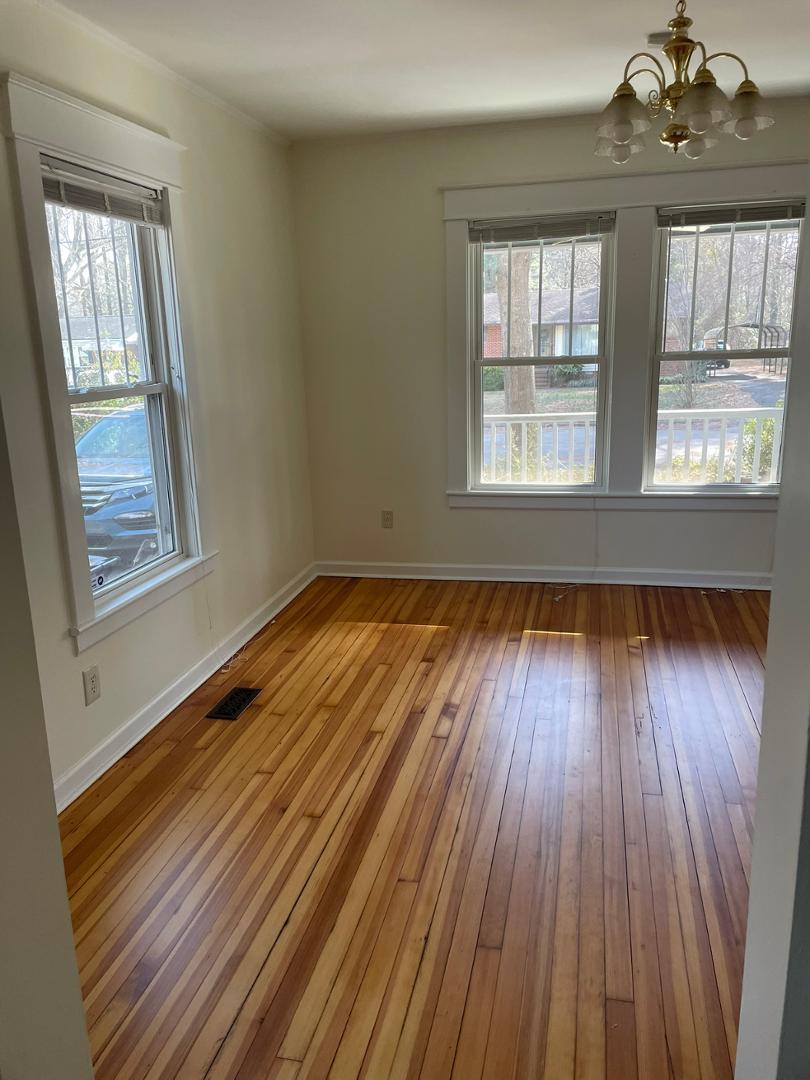 716 Crosby Road Durham, NC 27704 - Photo 6 of 17 a view of an empty room with wooden floor and a window
