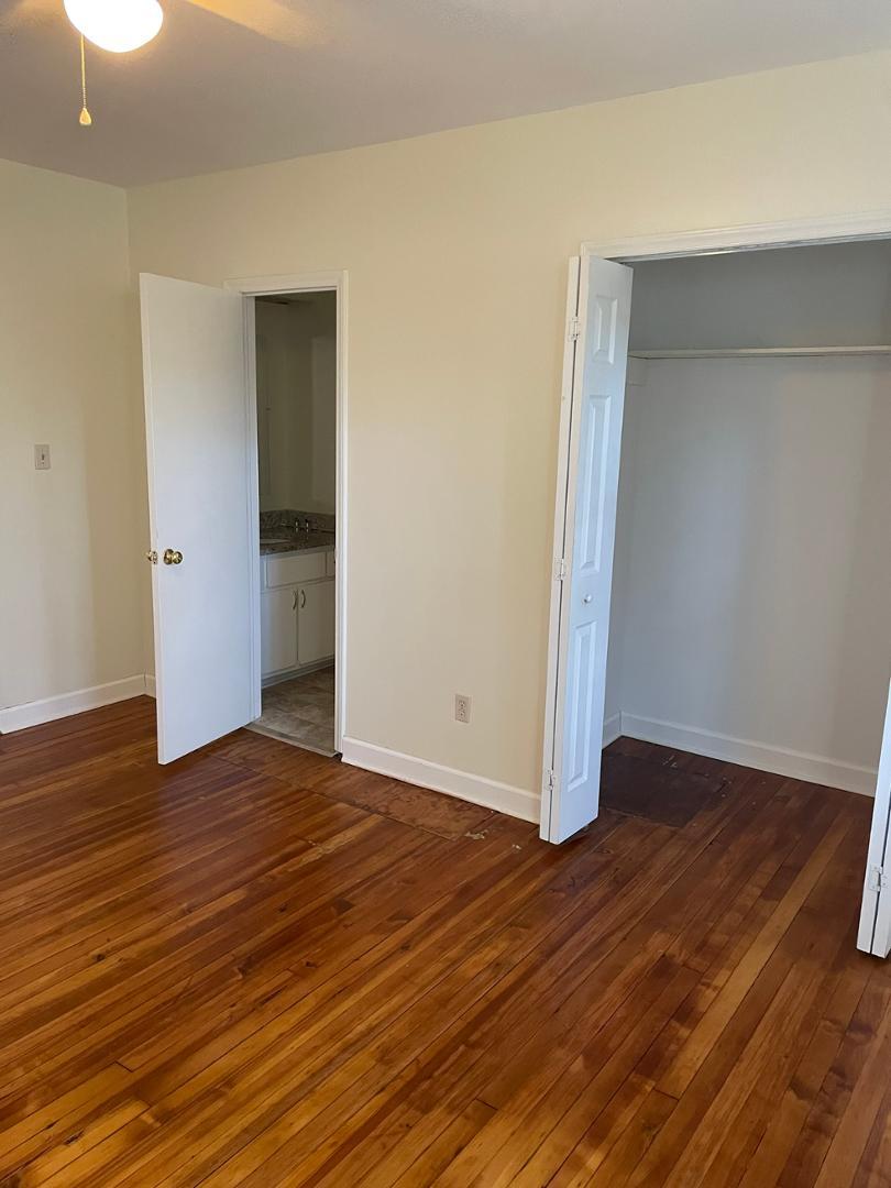 716 Crosby Road Durham, NC 27704 - Photo 10 of 17 a view of an empty room with wooden floor and closet