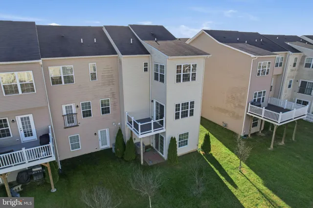 a white building with a big yard and a large tree