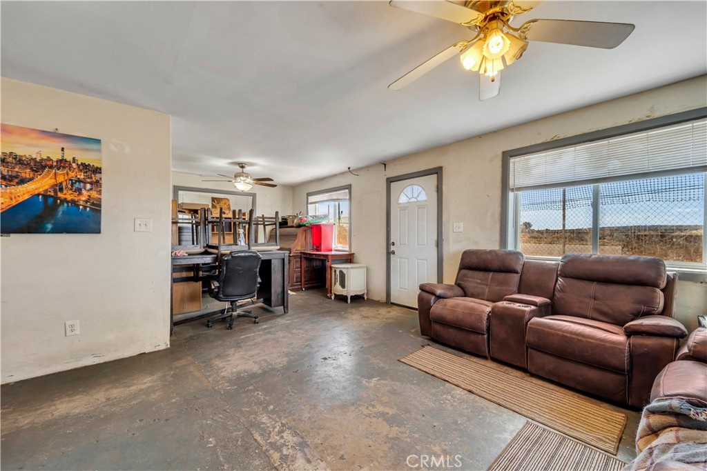 26447 Twenty Mule Team Road Boron, CA 93516 - Photo 28 of 61 a living room with furniture a ceiling fan and a window