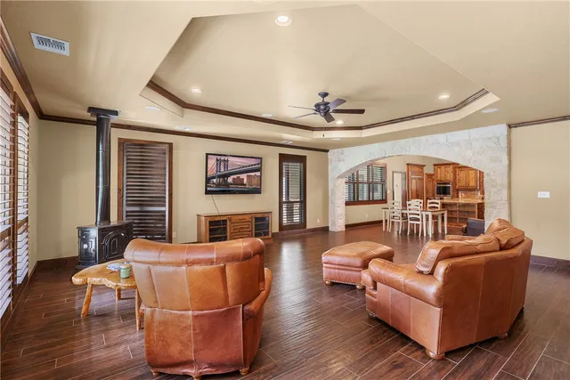 a living room with fireplace furniture and a wooden floor