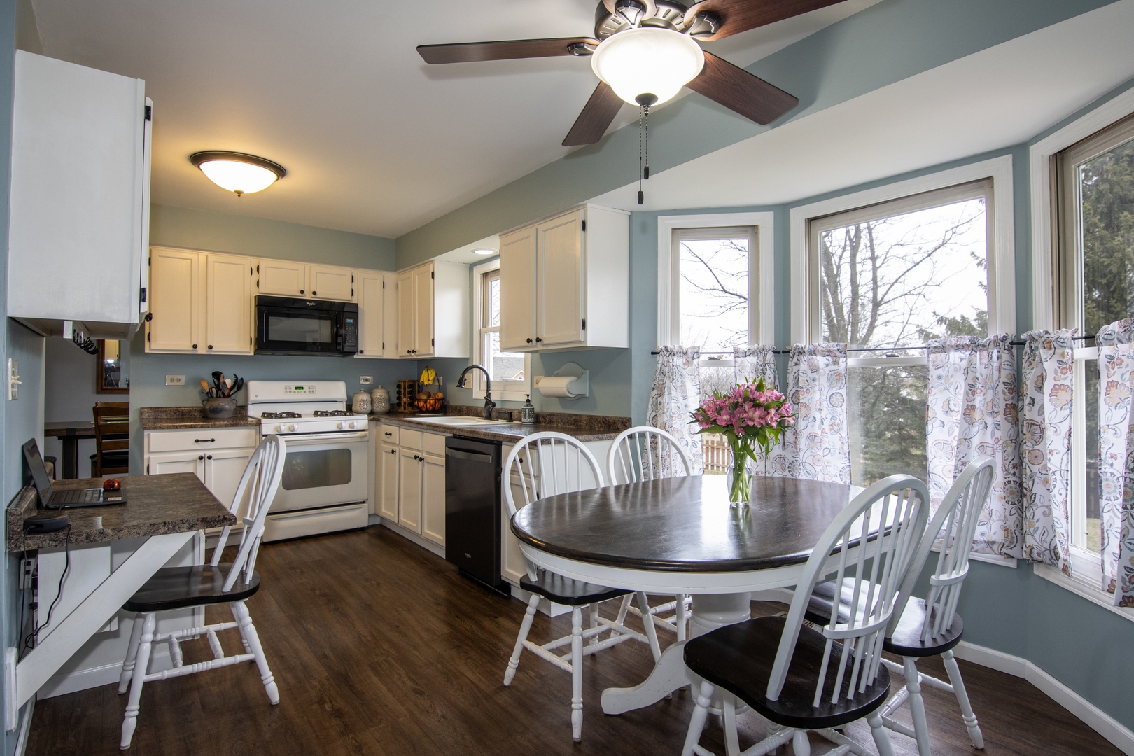 619 Chatham Circle Algonquin, IL 60102 - Photo 12 of 37 a kitchen with a dining table chairs stainless steel appliances and cabinets