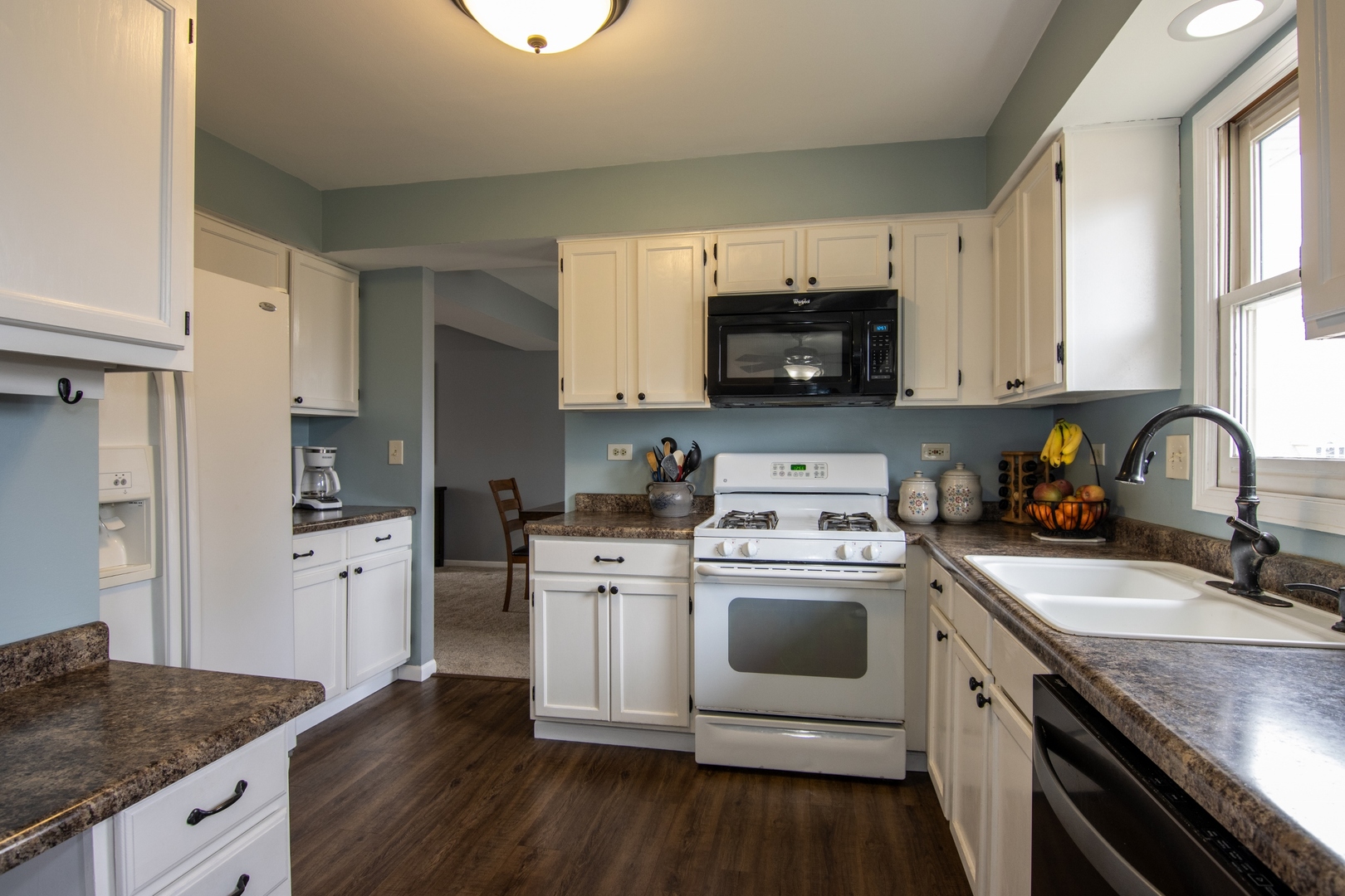 619 Chatham Circle Algonquin, IL 60102 - Photo 13 of 37 a kitchen with stainless steel appliances granite countertop a sink a stove a refrigerator cabinets and a window